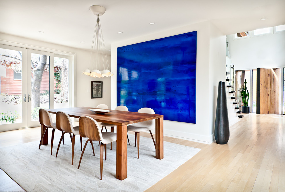 Large trendy light wood floor and beige floor dining room photo in Los Angeles with white walls