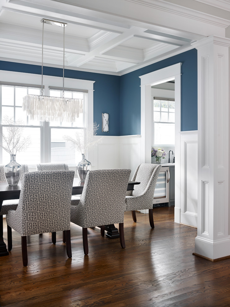 Example of a large minimalist medium tone wood floor enclosed dining room design in Atlanta with blue walls and no fireplace