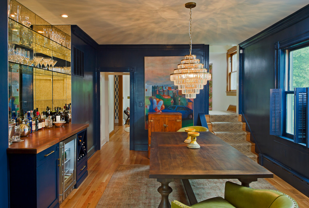 Inspiration for a transitional medium tone wood floor and brown floor enclosed dining room remodel in Baltimore with blue walls