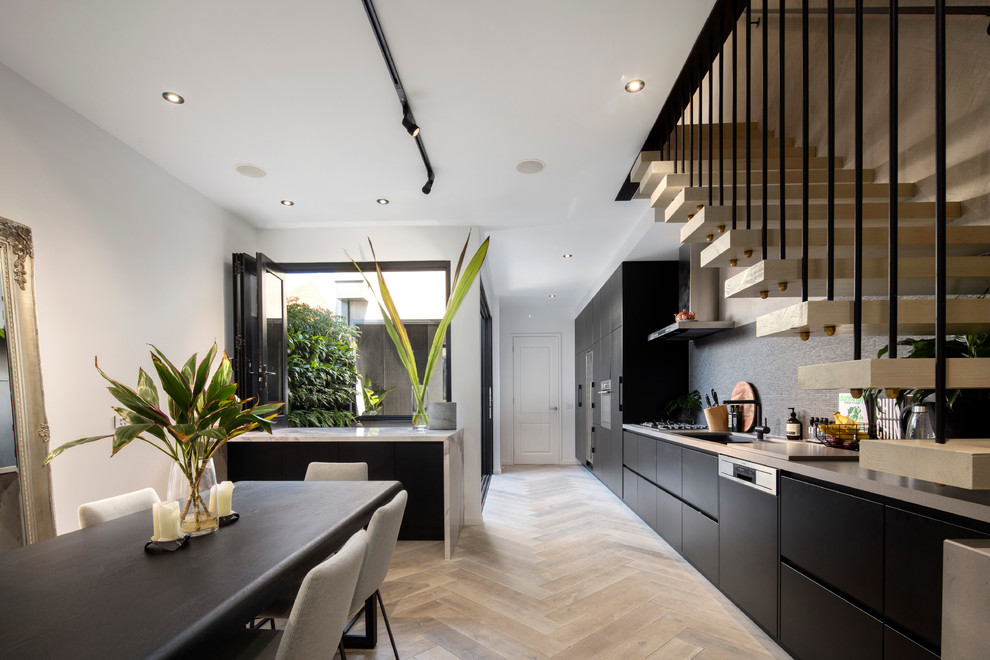 Example of a mid-sized trendy light wood floor kitchen/dining room combo design in Melbourne with white walls