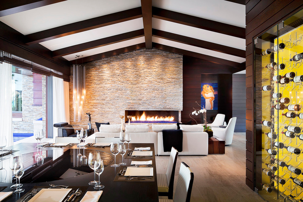 Minimalist dining room photo in Orange County with a stone fireplace