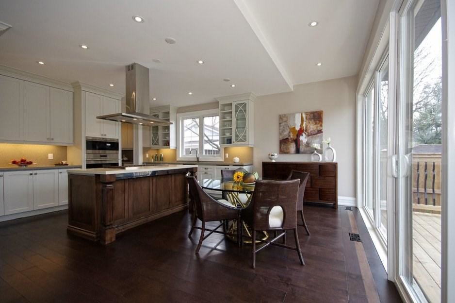 Mid-sized transitional dark wood floor and brown floor kitchen/dining room combo photo in Toronto with gray walls and no fireplace