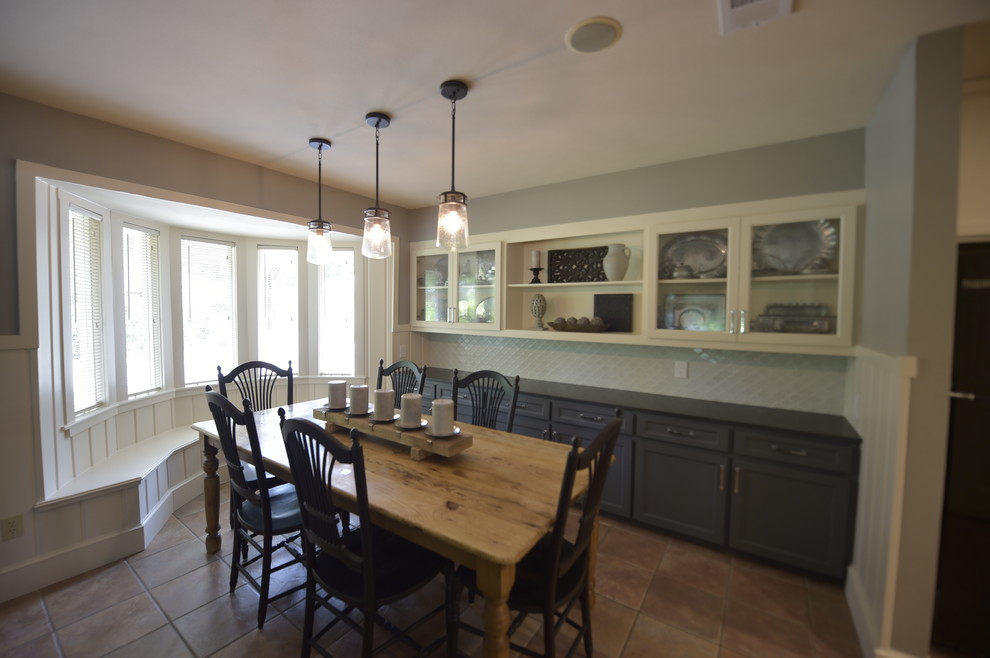 Photo of a country kitchen/dining room in Dallas with grey walls and brown floors.