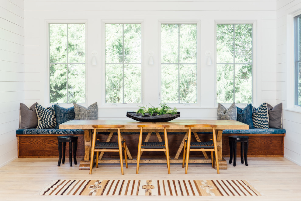 Example of a danish light wood floor and beige floor dining room design in Charleston with white walls and no fireplace