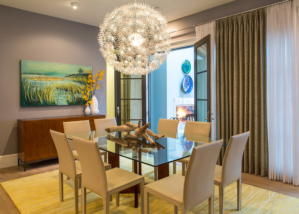 This is an example of a medium sized contemporary open plan dining room in Baltimore with grey walls and light hardwood flooring.