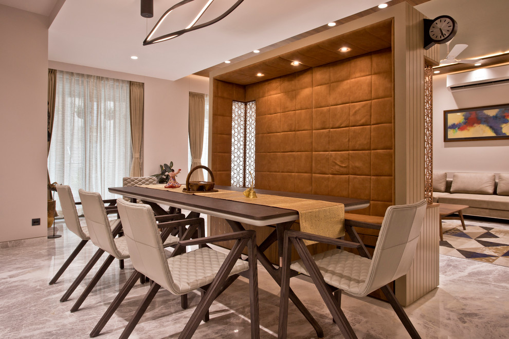 This is an example of a contemporary open plan dining room in Other with beige walls and grey floors.