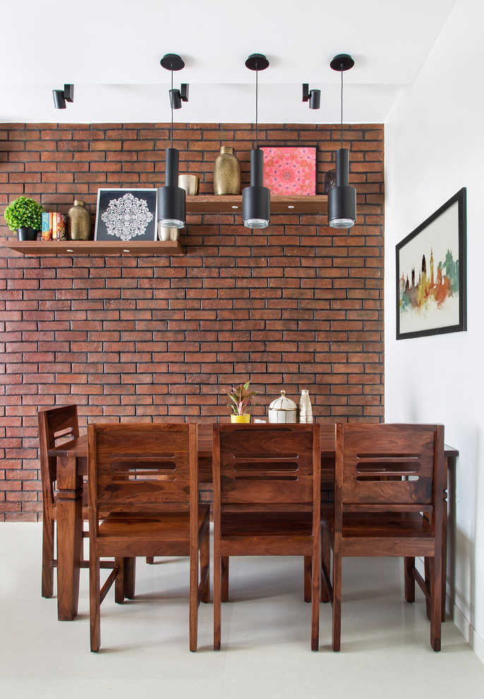 Photo of a contemporary dining room in Bengaluru with white walls, beige floors and a feature wall.