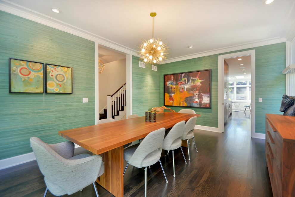 This is an example of a large contemporary enclosed dining room in Chicago with green walls and dark hardwood flooring.