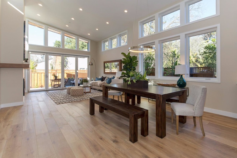 Inspiration for a large contemporary light wood floor and brown floor great room remodel in San Francisco with beige walls and no fireplace