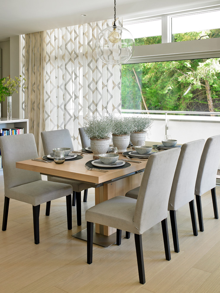 Inspiration for a transitional light wood floor dining room remodel in Surrey
