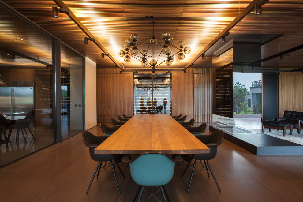 Immagine di una sala da pranzo minimalista con pareti marroni, pavimento in legno massello medio e pavimento marrone