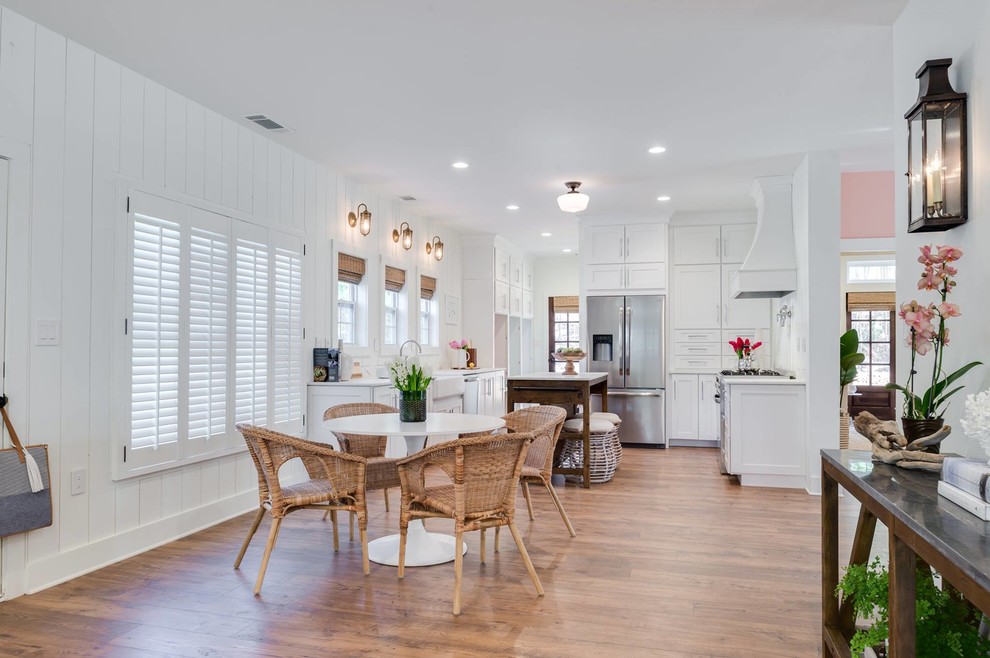 This is an example of a medium sized nautical open plan dining room in Birmingham with white walls, medium hardwood flooring, no fireplace and brown floors.