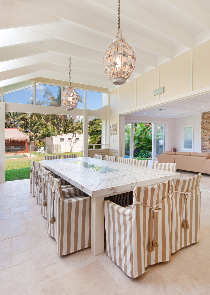 This is an example of a beach style open plan dining room in Sydney.