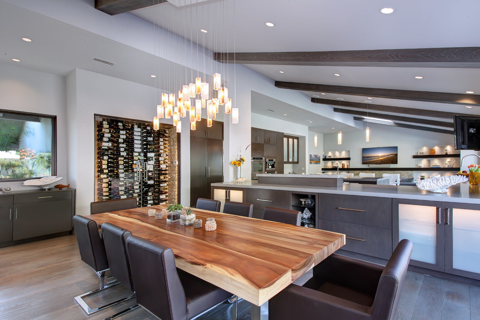 This is an example of a contemporary kitchen/dining room in Los Angeles with grey walls and medium hardwood flooring.