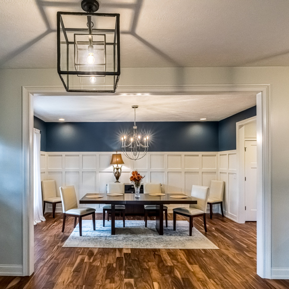 Example of a large arts and crafts medium tone wood floor and brown floor enclosed dining room design in Other with blue walls