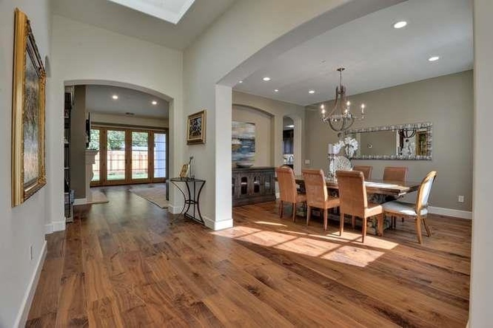 This is an example of an expansive rustic dining room in San Francisco with beige walls and medium hardwood flooring.