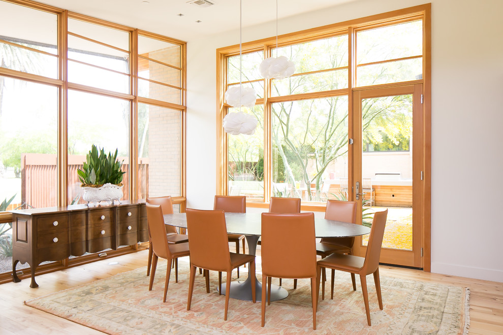 Design ideas for a retro dining room in Phoenix with white walls, light hardwood flooring, no fireplace and beige floors.
