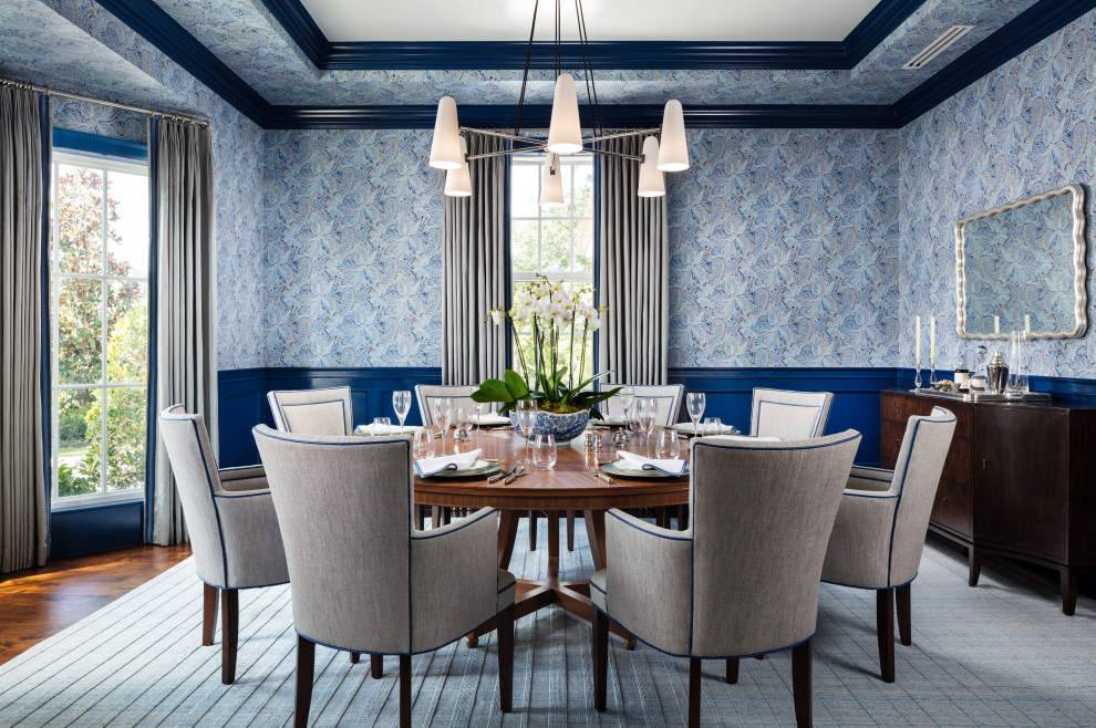 Example of an island style medium tone wood floor and brown floor enclosed dining room design in Miami with multicolored walls and no fireplace