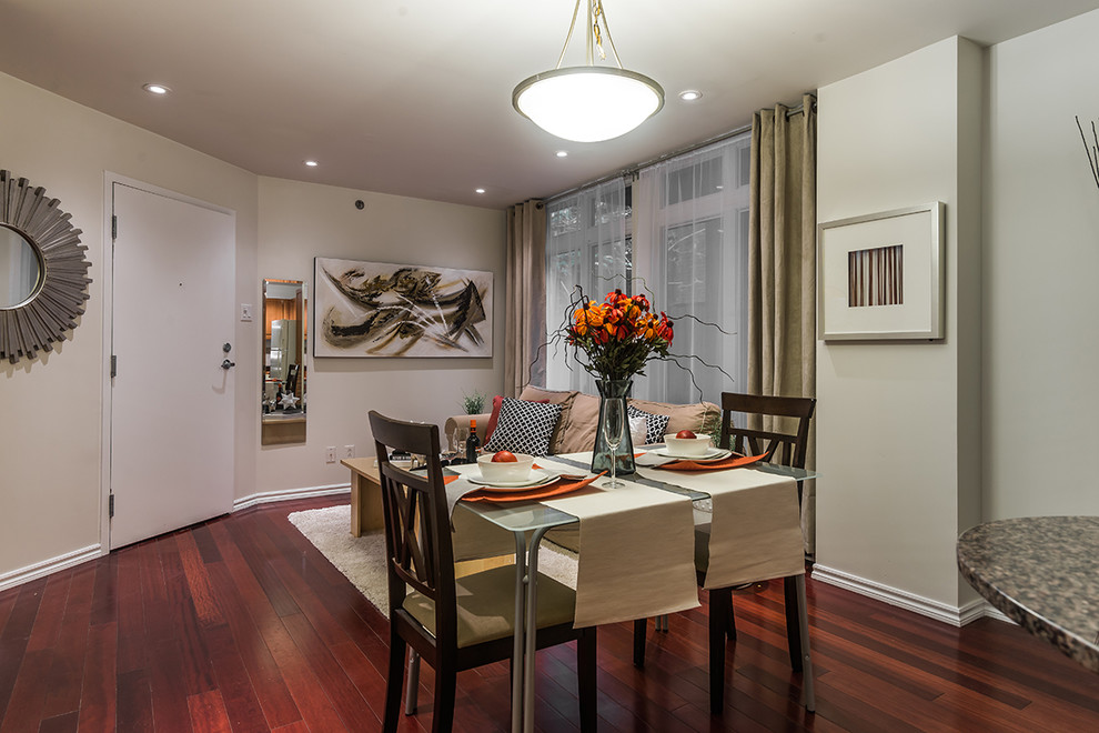This is an example of a small contemporary dining room in Montreal with beige walls and dark hardwood flooring.