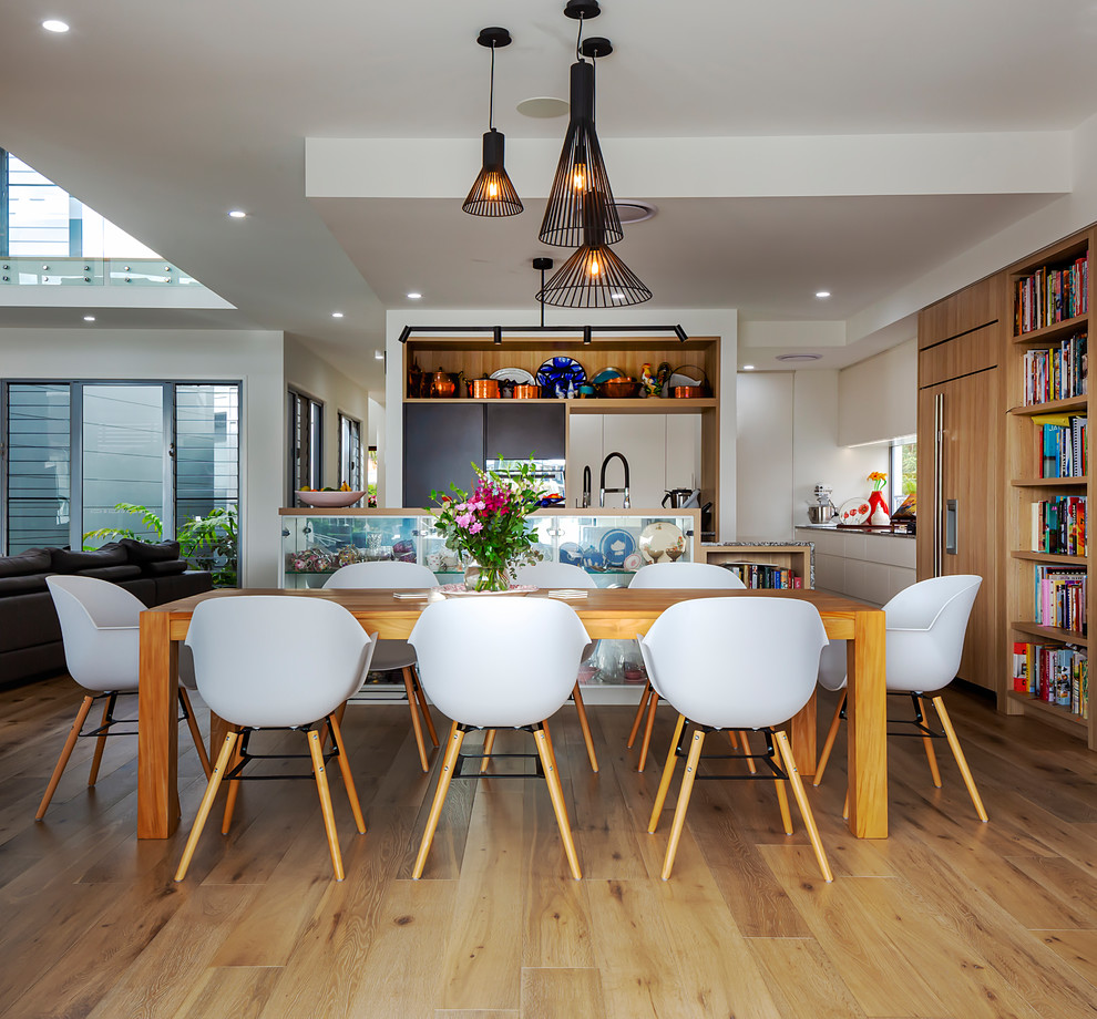 Inspiration for a contemporary medium tone wood floor and brown floor dining room remodel in Sunshine Coast with white walls