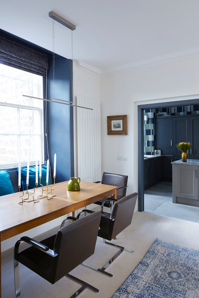 This is an example of a contemporary dining room in Edinburgh with blue walls.