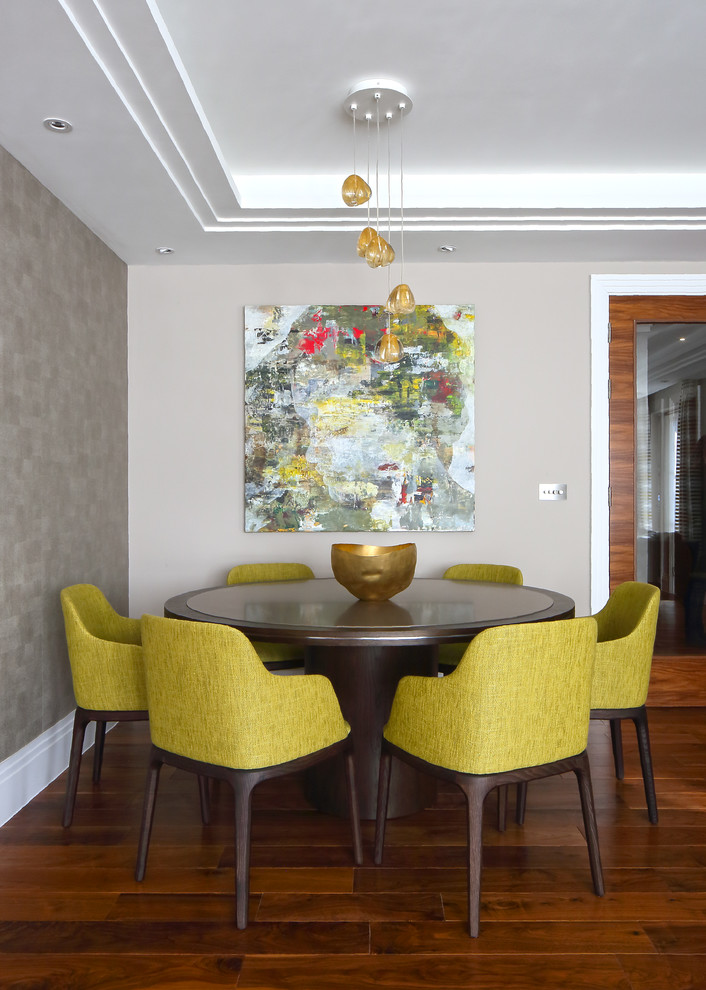 Traditional dining room in London with beige walls and dark hardwood flooring.