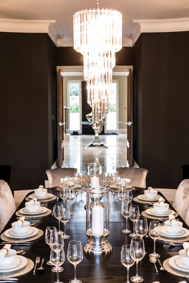 Photo of a traditional dining room in Surrey with black walls.