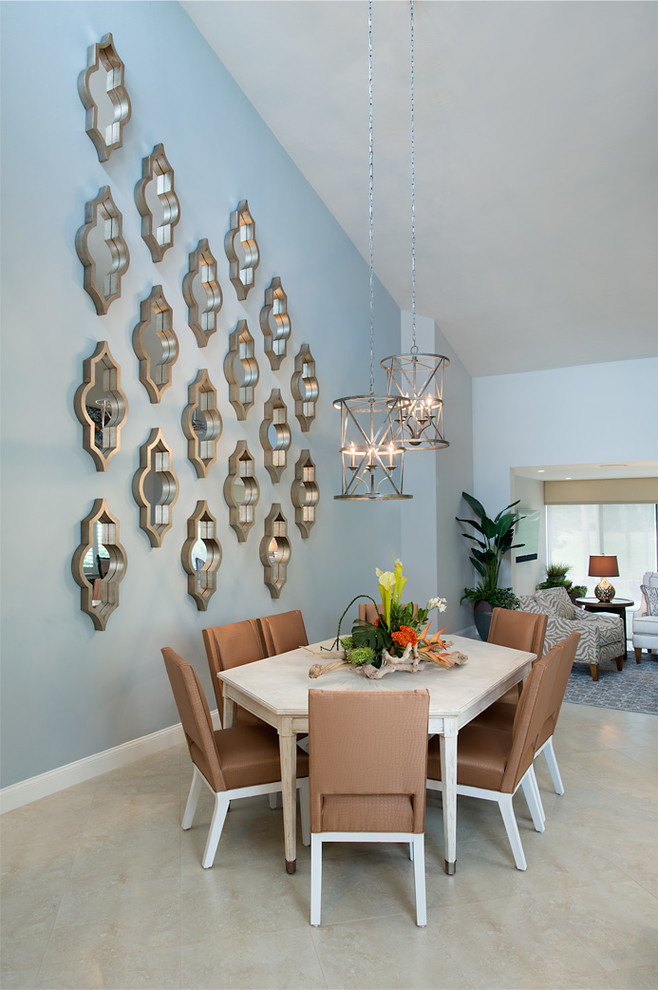 Inspiration pour une salle à manger ouverte sur le salon design avec un mur bleu, un sol beige et éclairage.