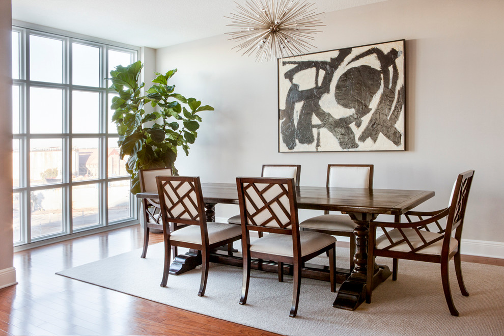 Large contemporary dining room in Tampa with beige walls, medium hardwood flooring, no fireplace and brown floors.