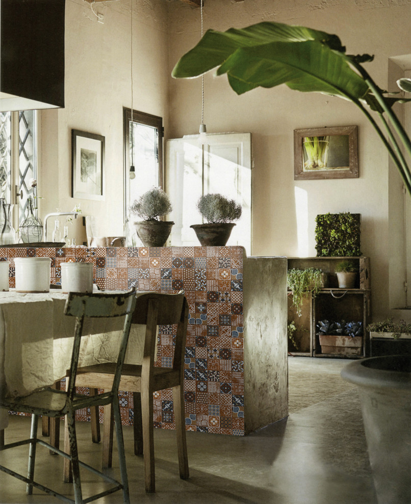 Inspiration for a mediterranean concrete floor kitchen/dining room combo remodel in Los Angeles with beige walls