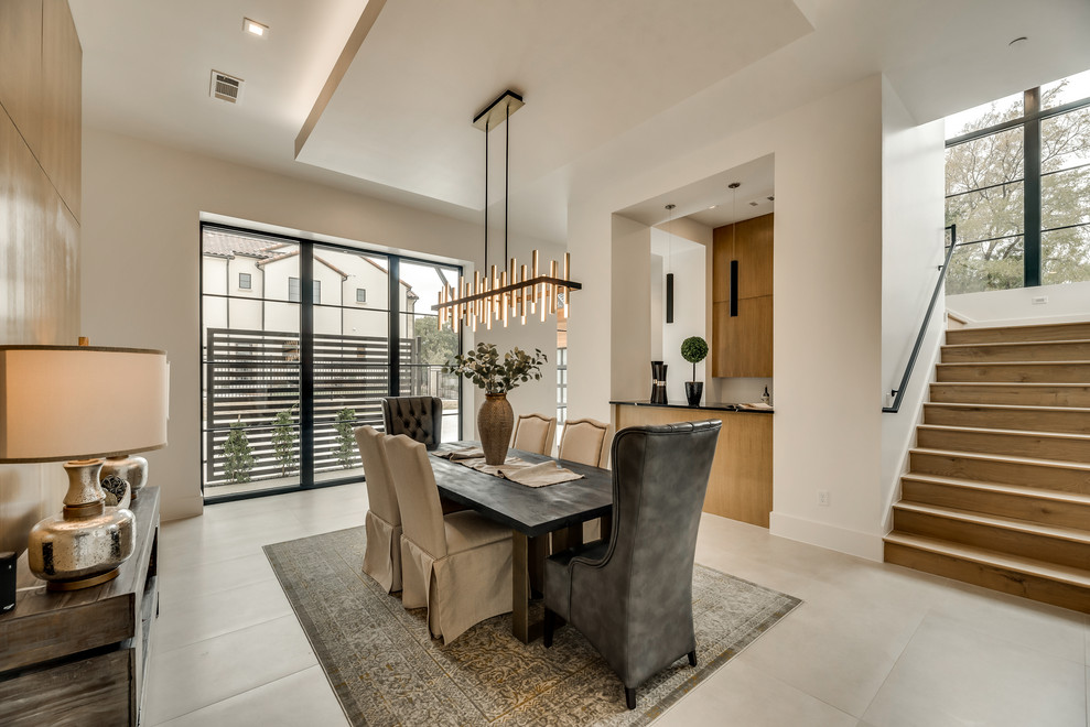 This is an example of a large contemporary open plan dining room in Dallas with beige walls and ceramic flooring.