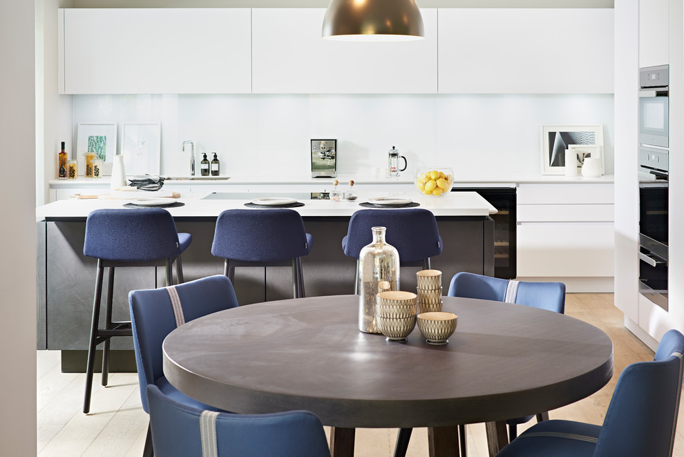 Idée de décoration pour une salle à manger ouverte sur la cuisine design de taille moyenne avec parquet clair et un sol beige.