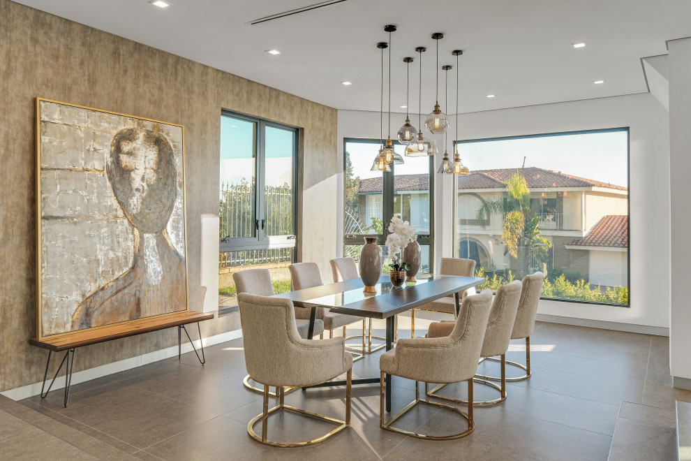 Photo of a contemporary dining room in Los Angeles with white walls, grey floors and wallpapered walls.