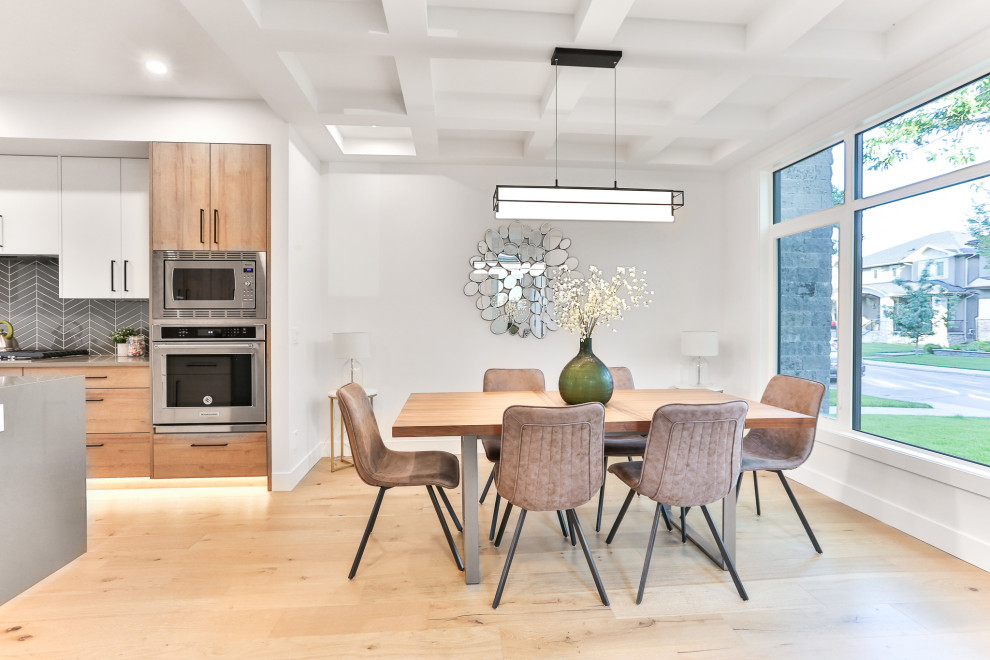 Aménagement d'une salle à manger ouverte sur la cuisine contemporaine de taille moyenne avec un mur blanc, parquet clair, un sol marron et un plafond à caissons.