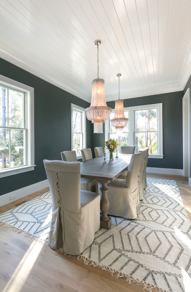 Example of a mid-sized beach style light wood floor and brown floor enclosed dining room design in Charleston with blue walls and no fireplace