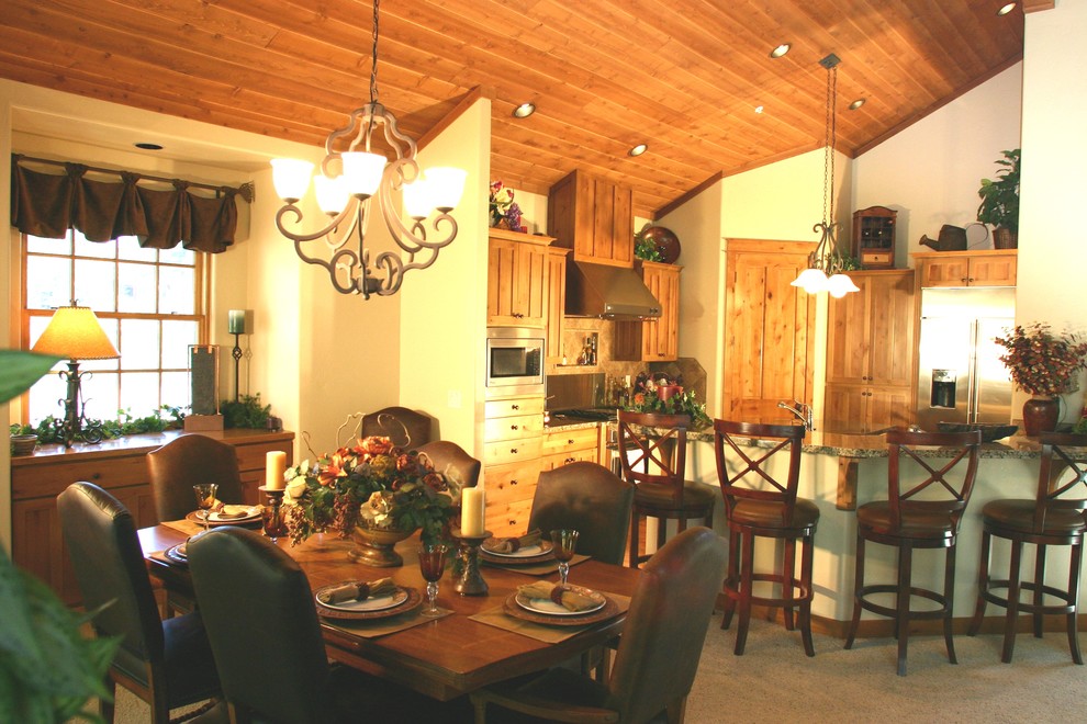 Foto di una sala da pranzo aperta verso la cucina di medie dimensioni con pareti bianche e moquette