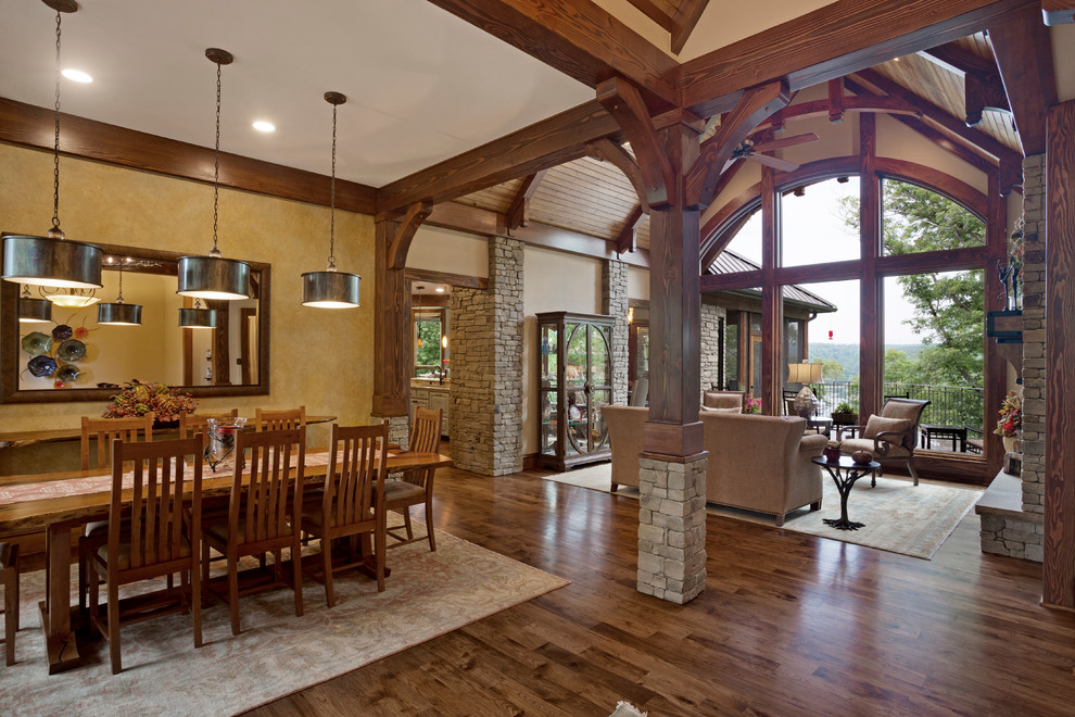 This is an example of a large traditional open plan dining room in Other with yellow walls and medium hardwood flooring.