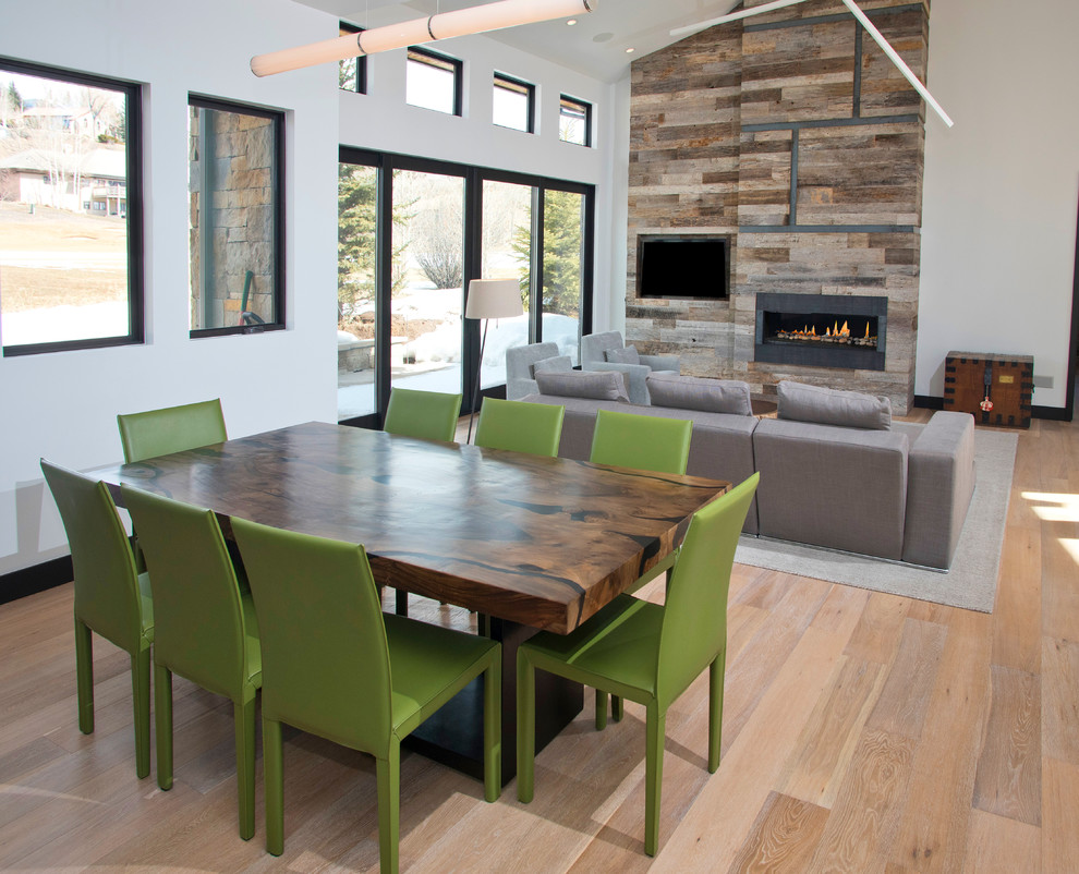 Inspiration for a medium sized modern kitchen/dining room in Denver with white walls, light hardwood flooring and feature lighting.