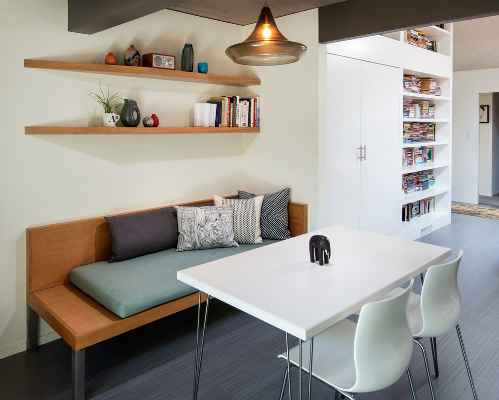 Idées déco pour une salle à manger contemporaine fermée et de taille moyenne avec un mur blanc, sol en stratifié, aucune cheminée et un sol gris.