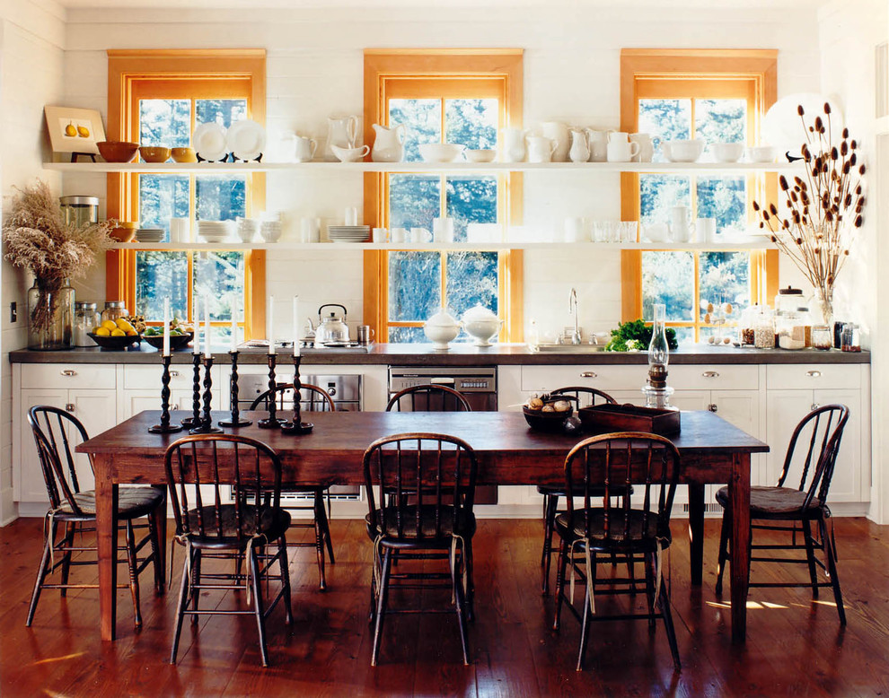 Dining room - rustic dark wood floor dining room idea in Seattle with white walls