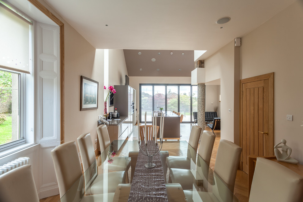 Ispirazione per una sala da pranzo aperta verso il soggiorno minimal di medie dimensioni con pareti beige e pavimento in legno massello medio