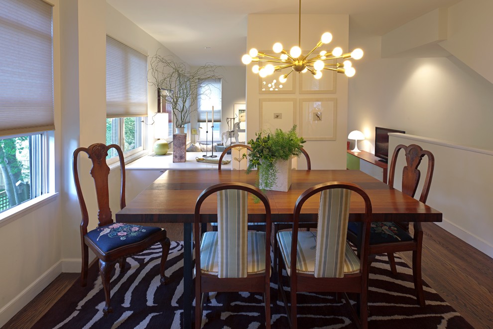 Medium sized eclectic dining room in Boston with white walls and dark hardwood flooring.