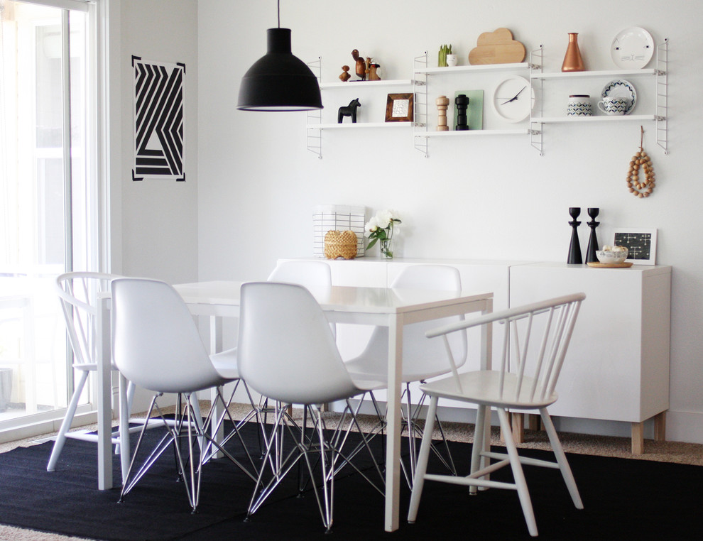 Example of a danish carpeted dining room design in Other with white walls