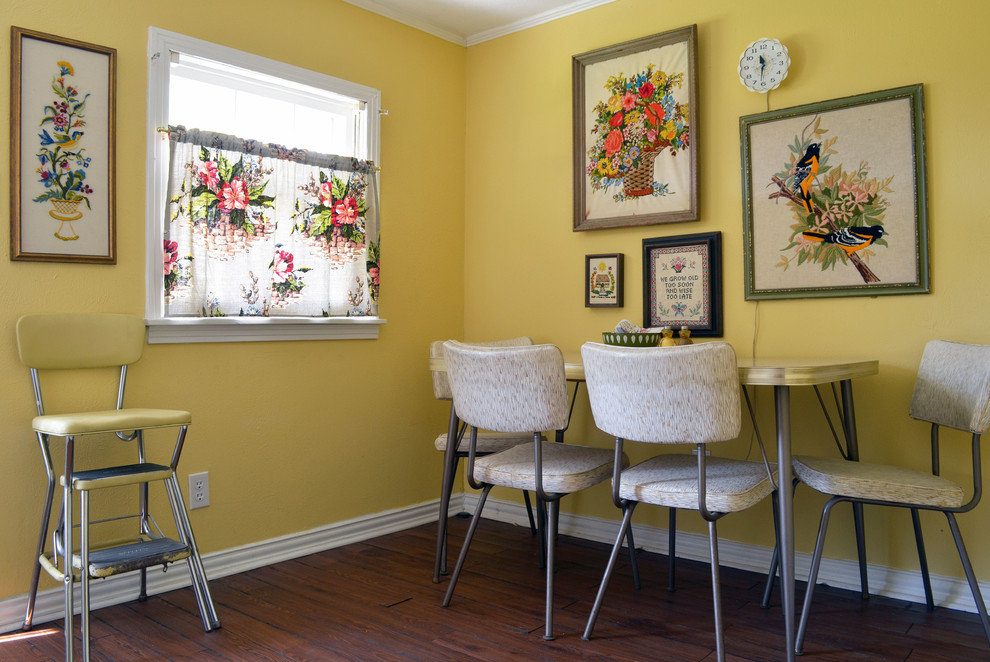 Photo of a bohemian dining room in Dallas with yellow walls and dark hardwood flooring.