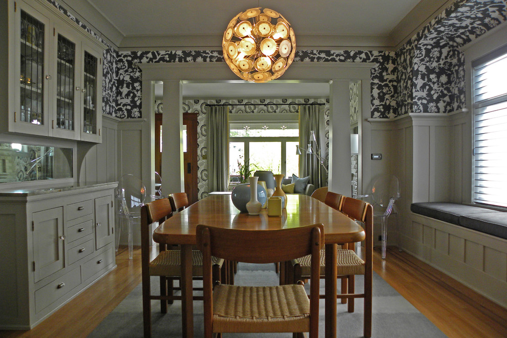 Arts and crafts medium tone wood floor dining room photo in Seattle with multicolored walls