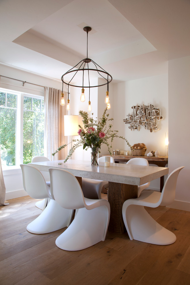 Design ideas for a contemporary dining room in San Francisco with white walls and medium hardwood flooring.