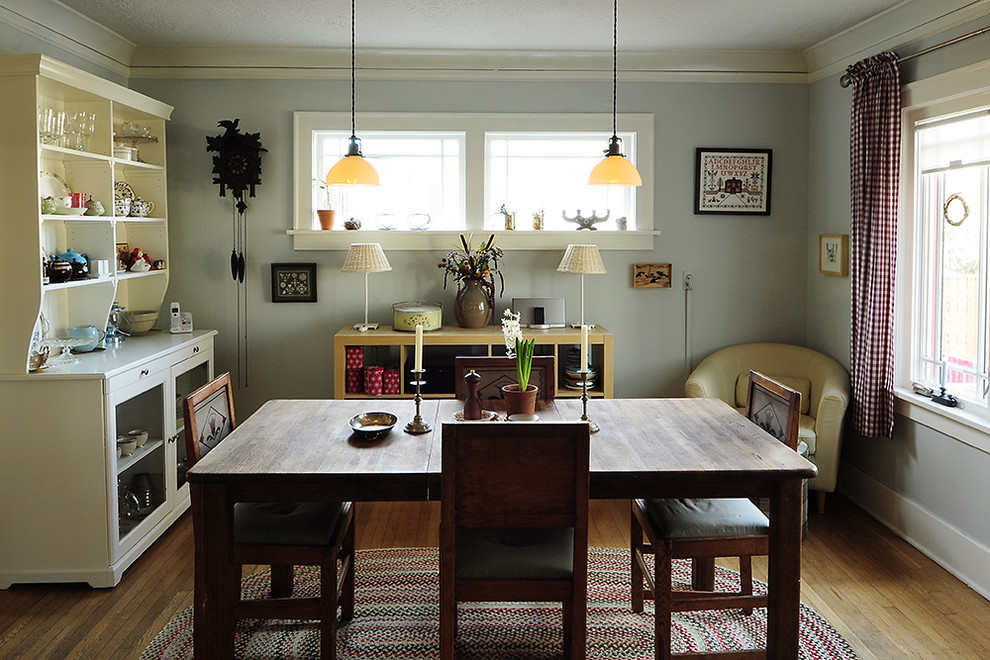 Example of a mountain style medium tone wood floor dining room design in Portland with gray walls