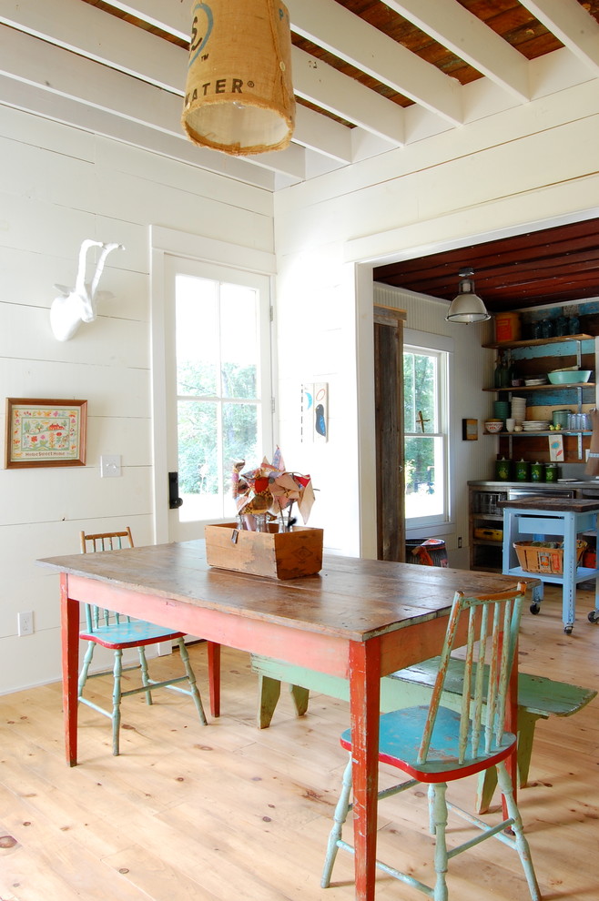 Inspiration for a rural dining room in New York with white walls.