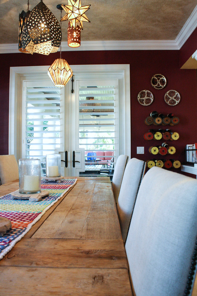 This is an example of a mediterranean dining room in Tampa with red walls.