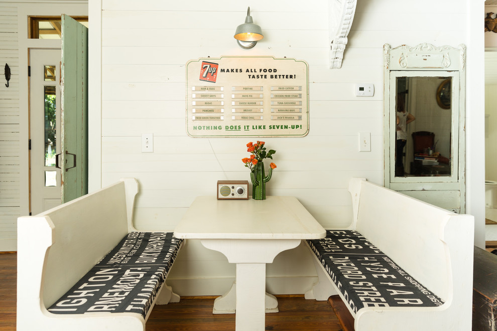 Vintage dining room in Austin with white walls, medium hardwood flooring and brown floors.